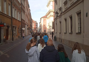 Uczniowie zwiedzają Stare Miasto w Warszawie.